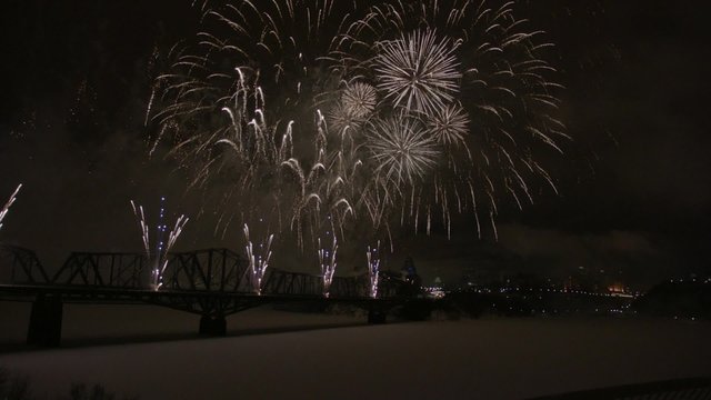 Slow motion fireworks over Alexandria Bridge crossing the Ottawa River during Winterlude.