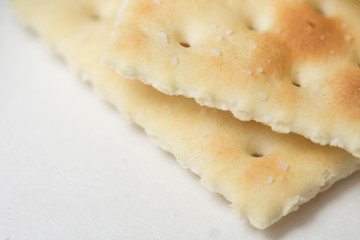 Closeup of a saltine cracker on a gray background