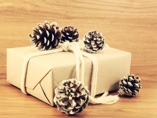 christmas present with pine cone with vintage filter effect retr
