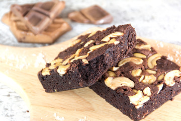 Chocolate brownie on wood plate