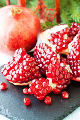 Ripe pomegranate on stone plate