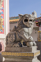 Protective Chinese lion at front door of buddhist temple.