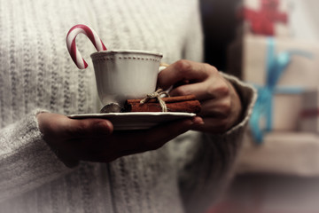 cup in hand and stack gifts