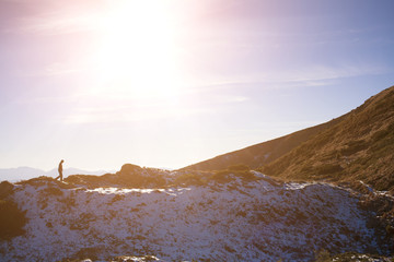 Silhouette of a climber on a mountain ridge.