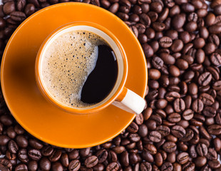 Coffee cup and coffee beans on table