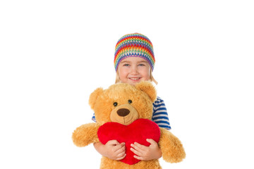 Little girl holding Teddy bear and heart.