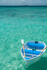 Rowing boat on the Indian Ocean with a Maldivian island on the horizon