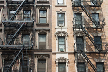 Fototapeta na wymiar The typical old houses with fire stairs in New York