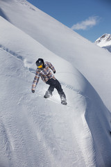 Flying snowboarder on mountains. Extreme sport.