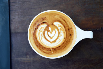 cup of latte art coffee on wooden background
