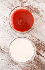 bowls of salsa on modern wooden base