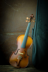 vintage violin resting against an old steel background