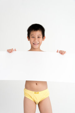 Asian boy wearing yellow underwear hand holding whiteboard copys