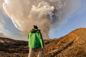 man look the Volcano eruption. Mount Etna erupting from the crater Voragine
