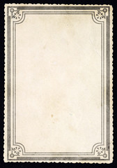 Old retro paper sheet with ornamental frame, isolated on black background.