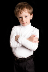 Portrait of the boy on a black background.