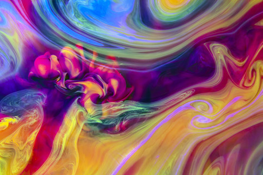 Abstract artistic background. Colors in water create psychedelic colorful organic shapes and structures that reveal themselves when closely observing the image.
