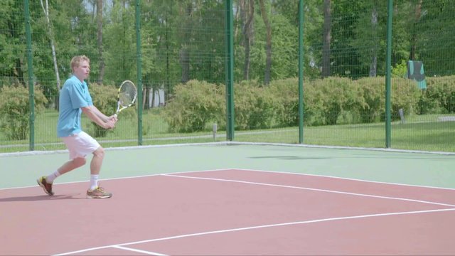 Power in action. Tennis backhand jump overhead shot. Slow Motion.The player shows his tennis skills.This session is full of many different extremely good shots