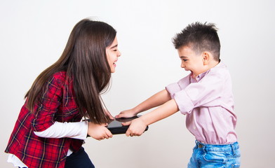brother and sister fighting for laptop