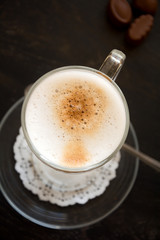 Latte Macchiato with chocolate on dark wooden table