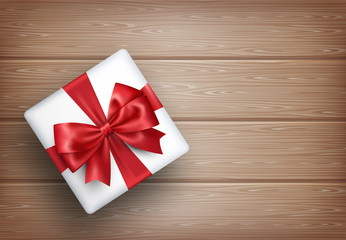 Present Gift Box with Bow on Wooden