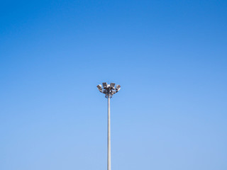 Light pole tower on clear blue sky.
