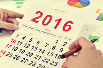 young businessman with a 2016 calendar