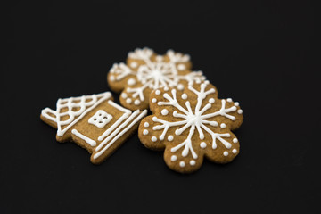 Gingerbread house and snowflakes on a black background