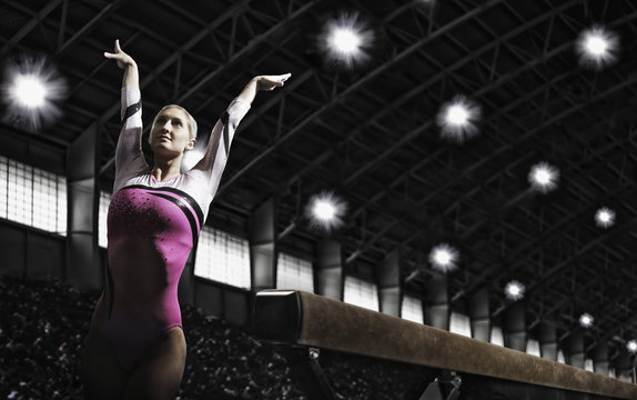 A gymnast with her arms raised and back arched
