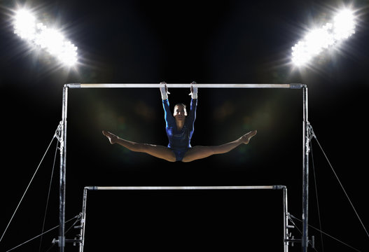 A gymnast on the parallel bars performing a routine