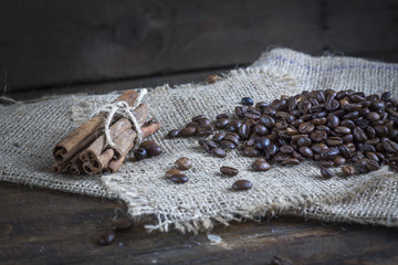 Coffee beans and cinnamon on a wooden background