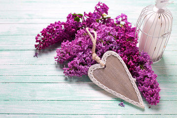 Background  with fresh lilac flowers and rustic  decorative hear