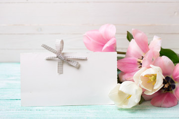 Postcard with fresh spring flowers and empty tag for your text