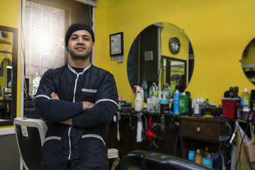 Barber posing in his shop.