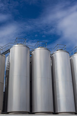 Giant industrial tanks on the bright blue sky