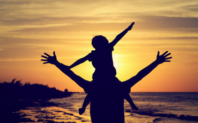 father and son having fun at sunset