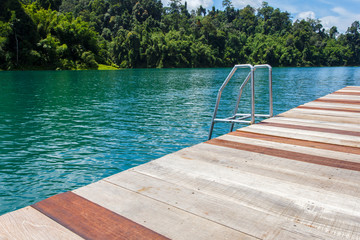 Obraz premium Grab bars ladder in lake forest and river natural attractions in Ratchaprapha Dam at Khao Sok National Park, Surat Thani Province, Thailand.