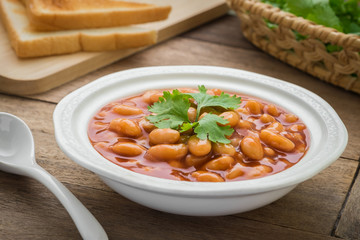 Baked beans in tomato sauce on plate and toast