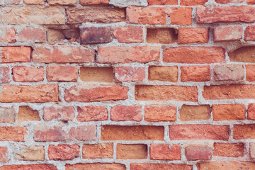 Old brick wall with bricks missing