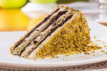 Slice of nut cake with chocolate cream