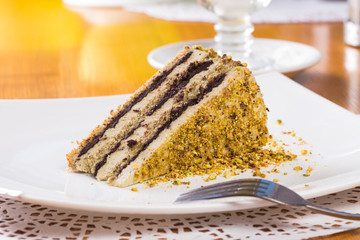Slice of nut cake with chocolate cream