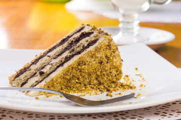 Slice of nut cake with chocolate cream