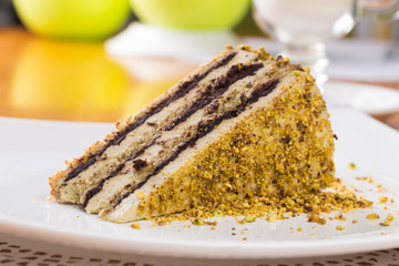 Slice of nut cake with chocolate cream