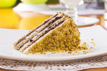 Slice of nut cake with chocolate cream