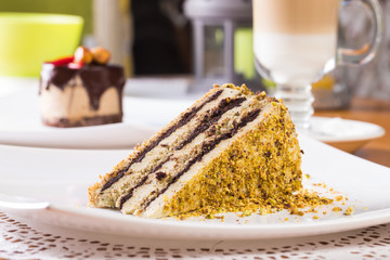 Slice of nut cake with chocolate cream