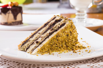 Slice of nut cake with chocolate cream