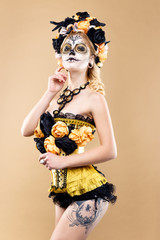 attractive young woman with sugar skull makeup,Dia de los Muertos - Mexican Day of the dead woman wearing sugar skull makeup and flower wreath.