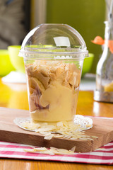 Creamy dessert in plastic cup