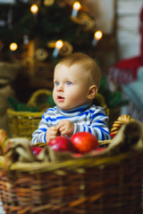 Fototapeta na wymiar one years old child celebrating holidays near Christmas tree