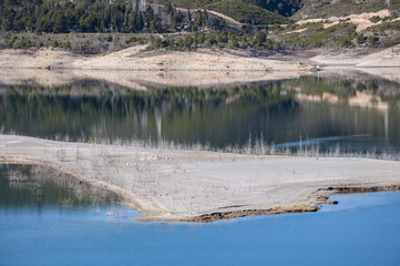 Views of Buendia Reservoir, in the upper waters of the river Tagus, Cuenca, Spain. The surface area of the reservoir measures 8,194 hectares, and it can hold a total of 1,638 cubic hectometres.